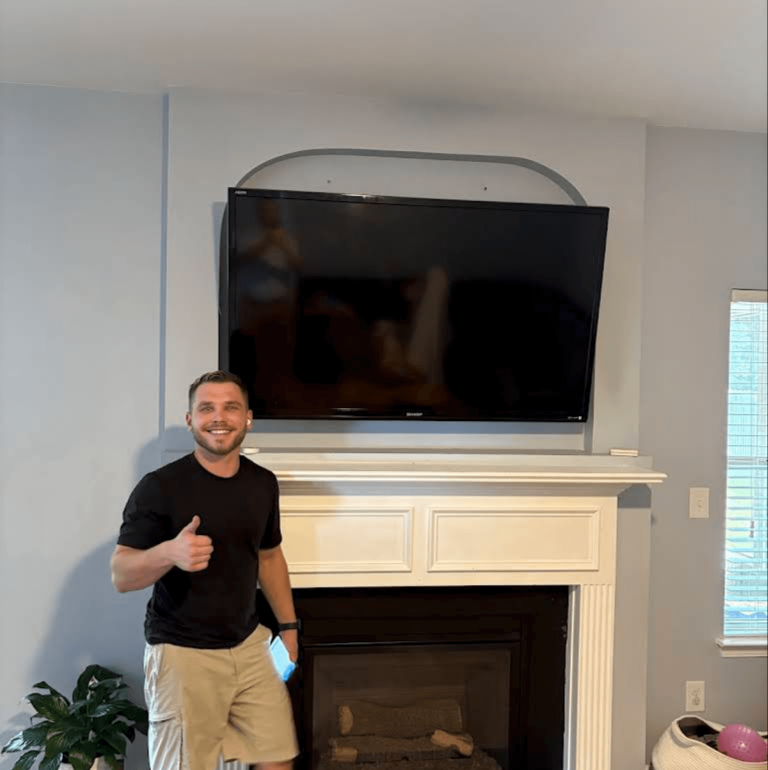 TV mounted above fireplace with exposed wire routing – our best master